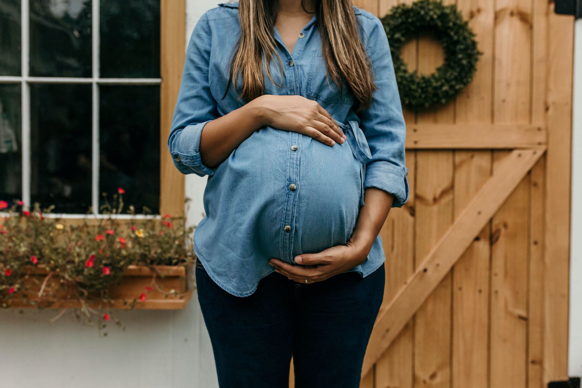 a pregnant woman in a blue shirt